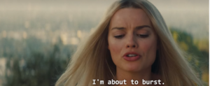 Margot Robbie with troubled face saying "I'm about to burst"